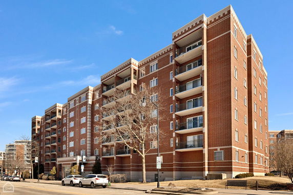Front view of a multi-story apartment building with balconies.