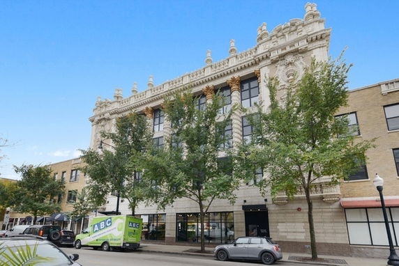 Front view of a multi-story building with ornate architectural details.