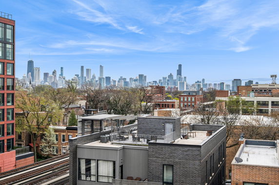 Panoramic view of city skyline and surrounding buildings.