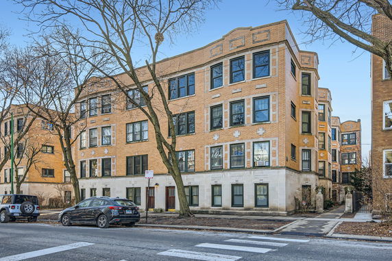 Front view of a multi-story residential building with brick facade.