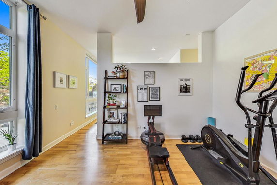 Indoor area with exercise equipment and wall decor.