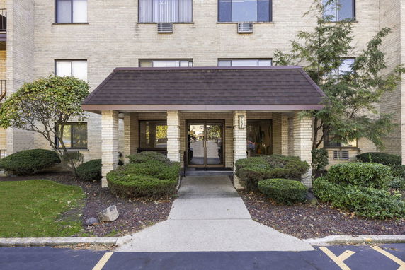 Front view of a multi-story building with a covered entrance.