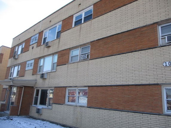 Front view of a multi-story brick apartment building.