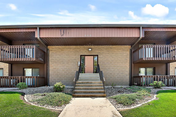 Front view of a two-story building with balconies.