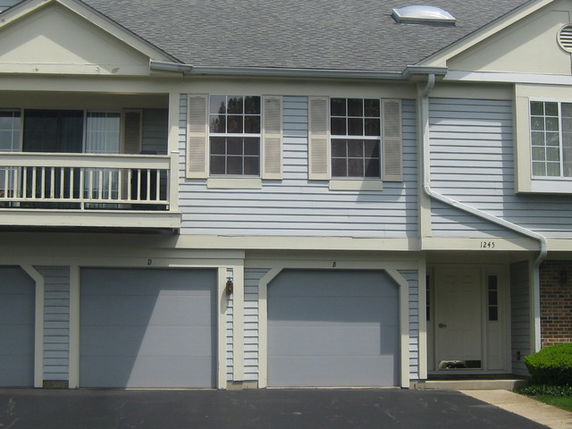 Front view of a two-story house with attached garage doors.