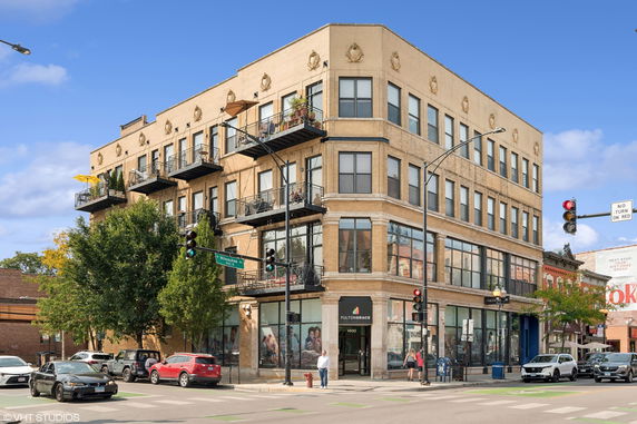 Front view of a multi-story building with balconies on each floor.
