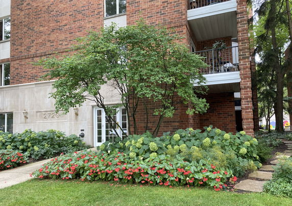 Front view of a brick residential building with balconies.