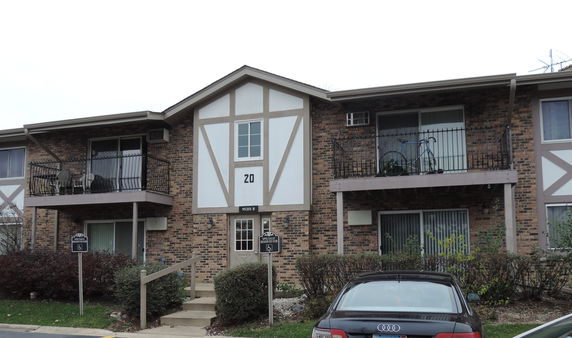 Front view of a two-story apartment building with balconies.