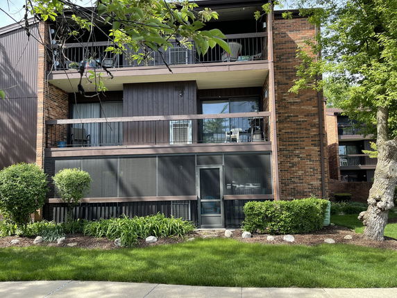 Front view of a multi-story residential building with balconies.