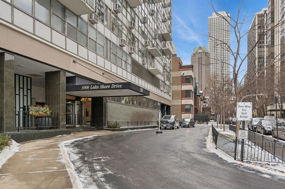 Front view of a multi-story building with a covered entrance labeled 1000 Lake Shore Drive.