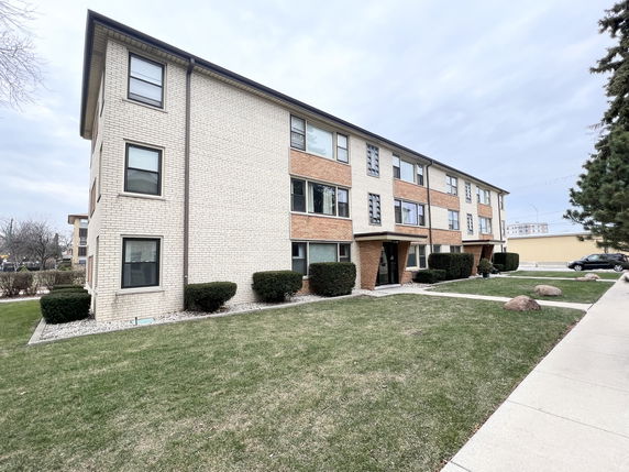 Front view of a three-story brick apartment building.