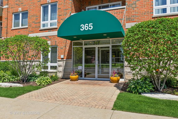 Front view of a building with a green canopy entrance.