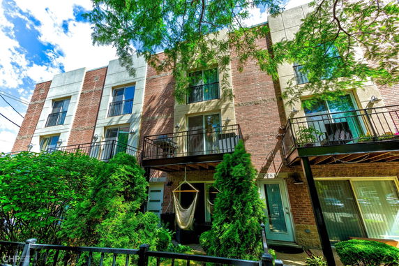 View of a multi-story brick building with balconies.
