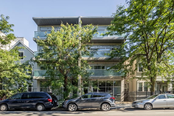 Front view of a modern multi-story building with balconies.