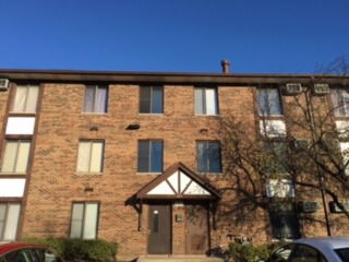 Front view of a three-story brick apartment building.