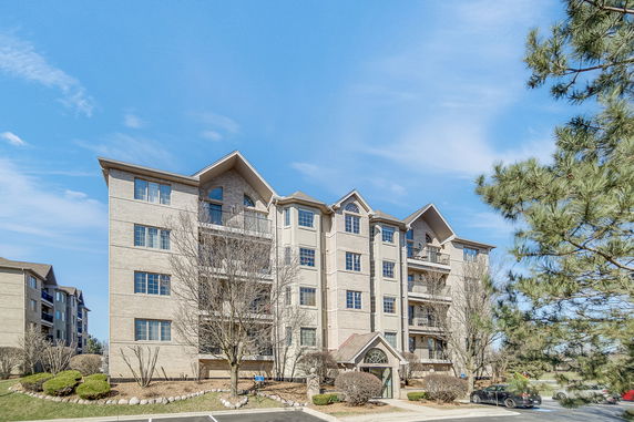 Front view of a multi-story residential building with balconies.