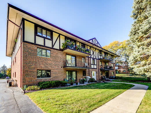 Front view of a multi-story apartment building with balconies.