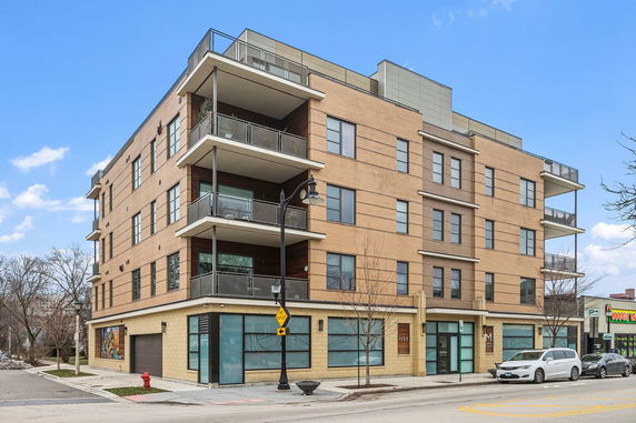 Front view of a multi-story apartment building with balconies.