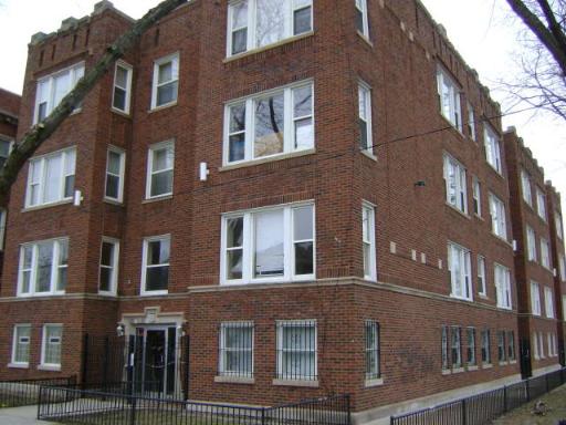 Front view of a multi-story brick apartment building.