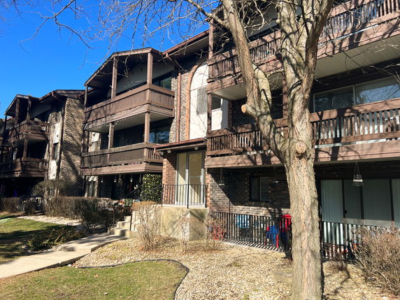 Front view of a multi-story residential building with balconies.