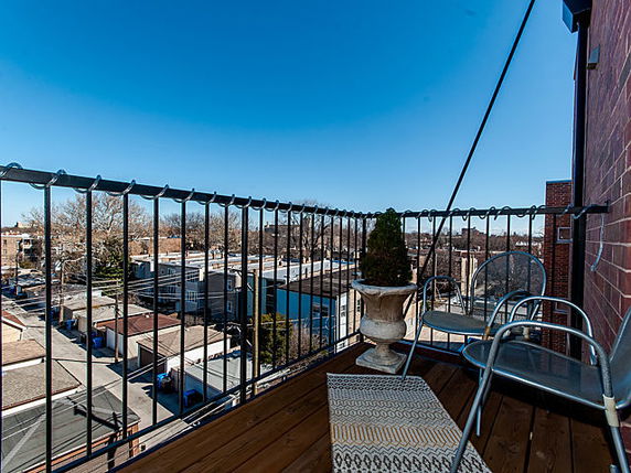 View of surrounding areas from a balcony with seating.