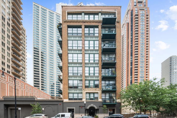 Front view of a mid-rise apartment building with balconies.