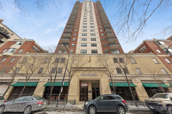 Front view of a tall multi-story building with balconies.