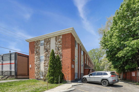 Front view of a two-story brick building with stone accents
