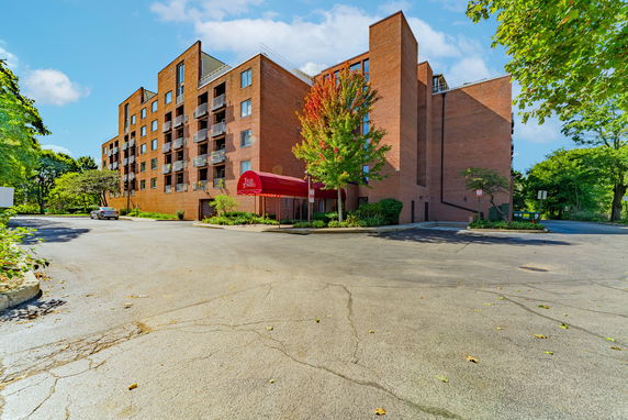 Front view of a multi-story brick building with balconies.