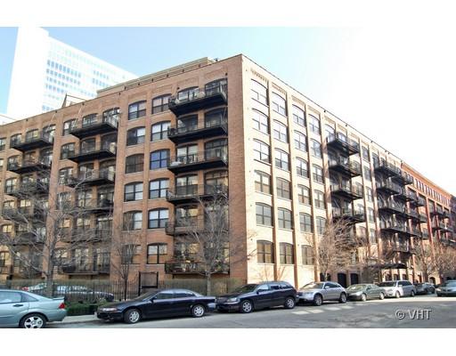Front view of a multi-story brick apartment building with several balconies.