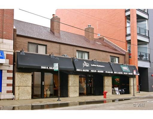 Front view of a two-story commercial building with awnings.
