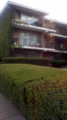 Front view of a multi-story apartment building with balconies.