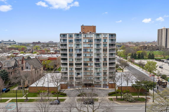 Front view of a multi-story apartment building with balconies.