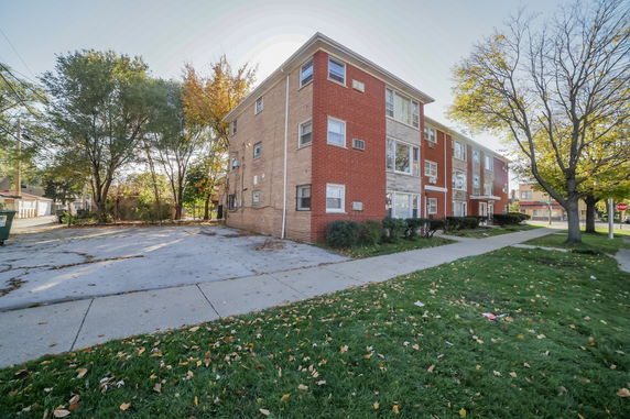 Front view of a three-story brick apartment building.