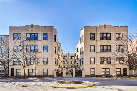 Front view of two adjacent multi-story apartment buildings