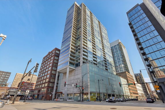Front view of a modern multi-story building with glass exterior.