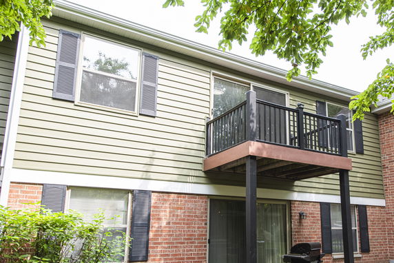 Exterior view of a two-story house with a small balcony on the upper floor.