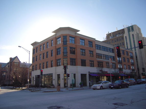 Front view of a multi-story commercial building on a street corner.