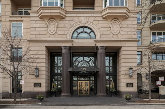 Front view of a building with grand entrance and columns.
