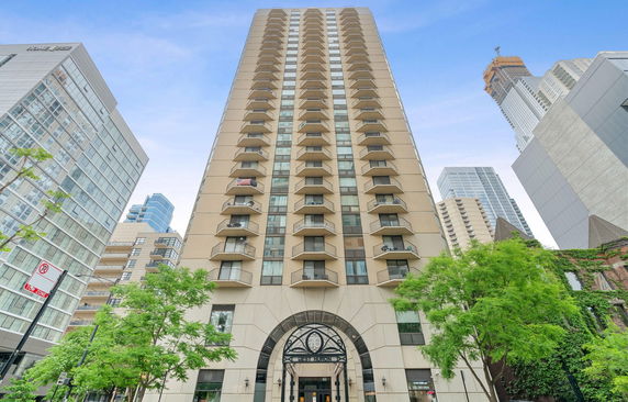 Front view of a tall multi-story building with balconies.