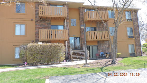 Front view of a multi-story apartment building with balconies.