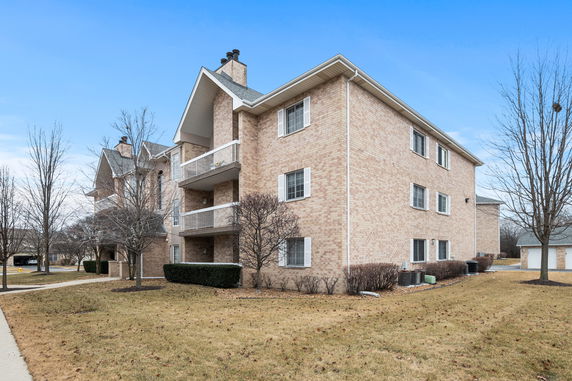 Front view of a three-story brick apartment building.