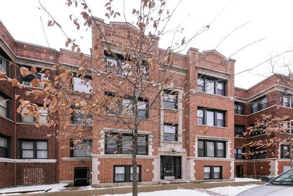 Front view of a multi-story brick apartment building.