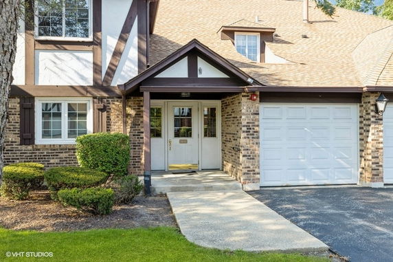 Front view of a house with a garage and entrance.