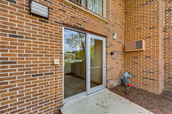 Entrance view of a brick building with a glass door.