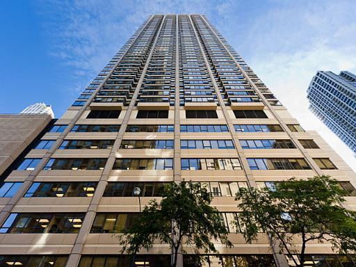 Front view of a tall skyscraper with glass windows.