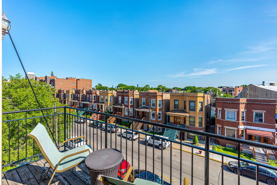 View of residential street with row houses from a balcony.