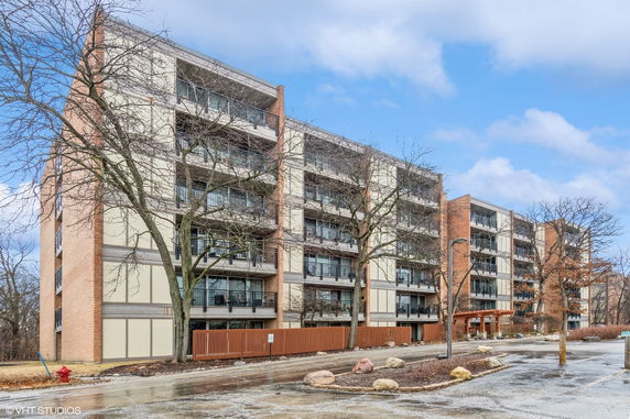 Front view of a multi-story apartment building with balconies.