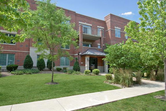 Front view of a multi-story brick building with balconies.