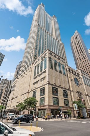Front view of a tall commercial building with distinctive architectural features.